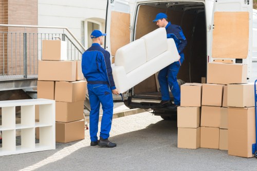 Removal team loading boxes as part of ethical Bow moving services