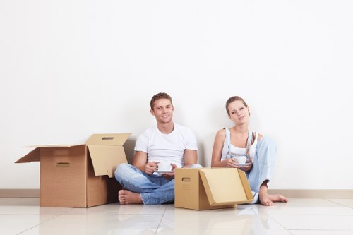 Boxes, furniture, and packing supplies ready for a residential move in Bow
