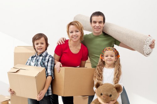 Local packing team helping with fragile household items in Bow